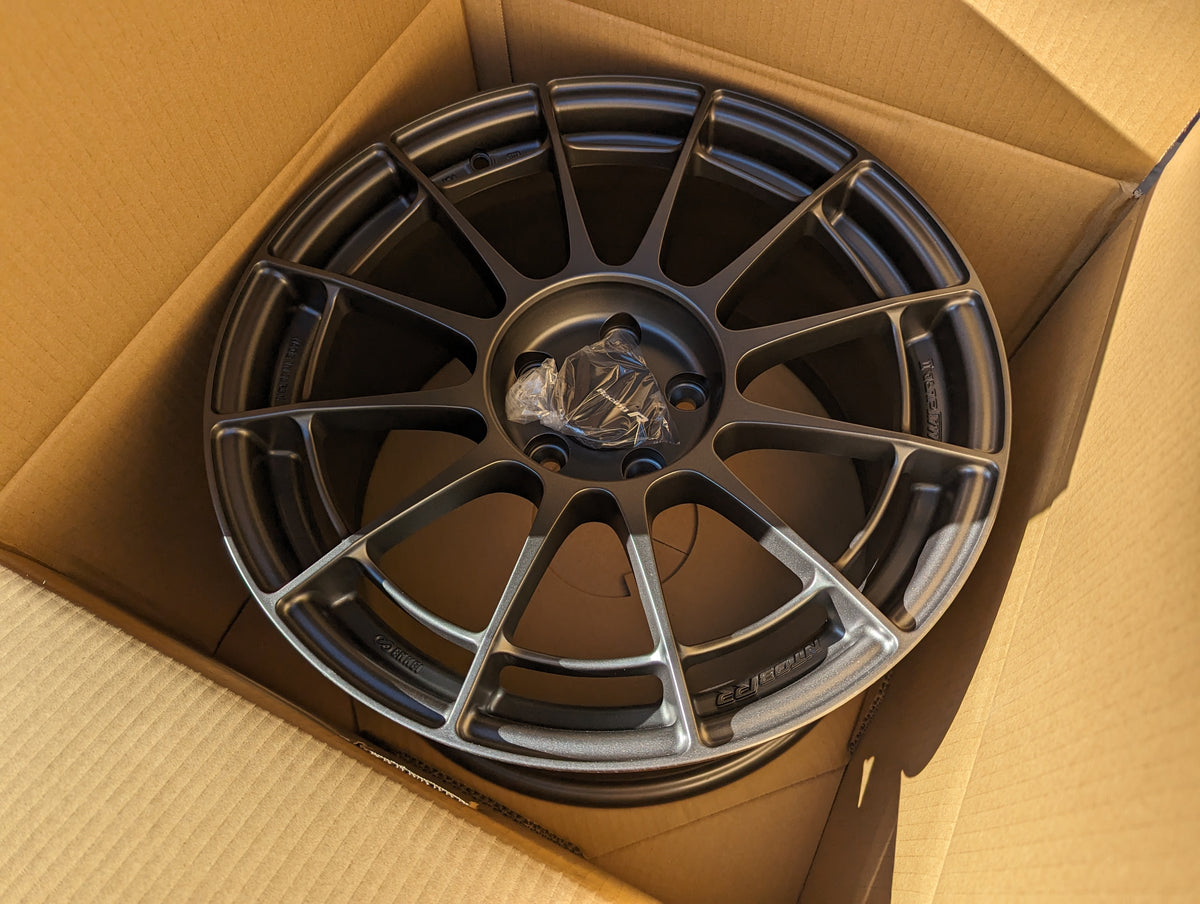 Enkei NT03+ (Dark Gunmetal) with Genuine Enkei Center Caps - 5x114.3 - 18x9.5 +40