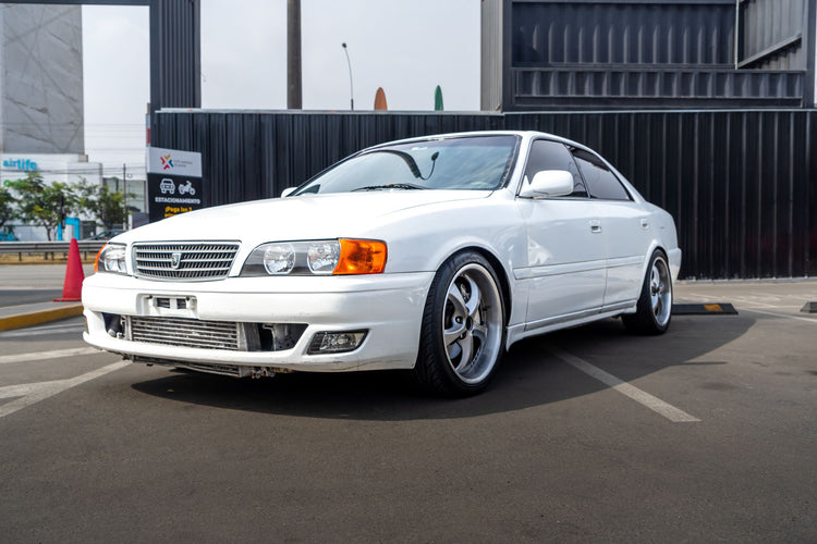 Toyota Chaser JZX100 photographed outdoors on a clean city street; illustrative guide photo